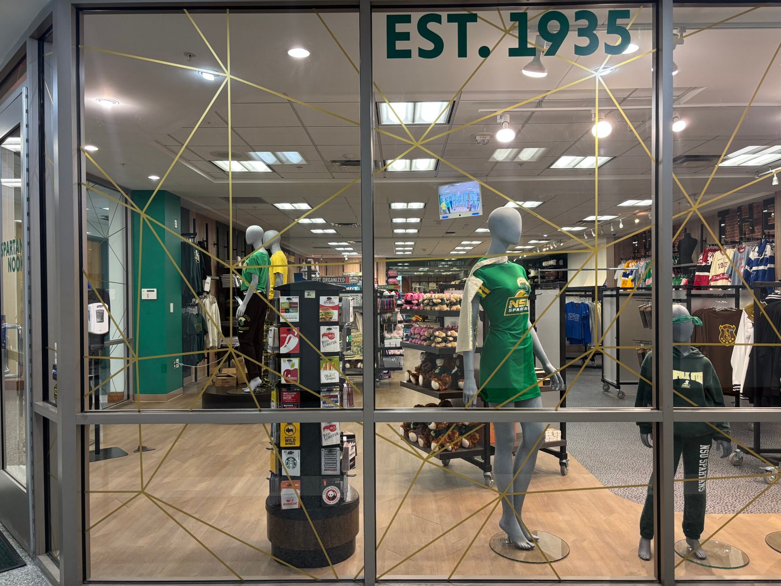 Decorative gold-line window film with EST. 1935 branding
