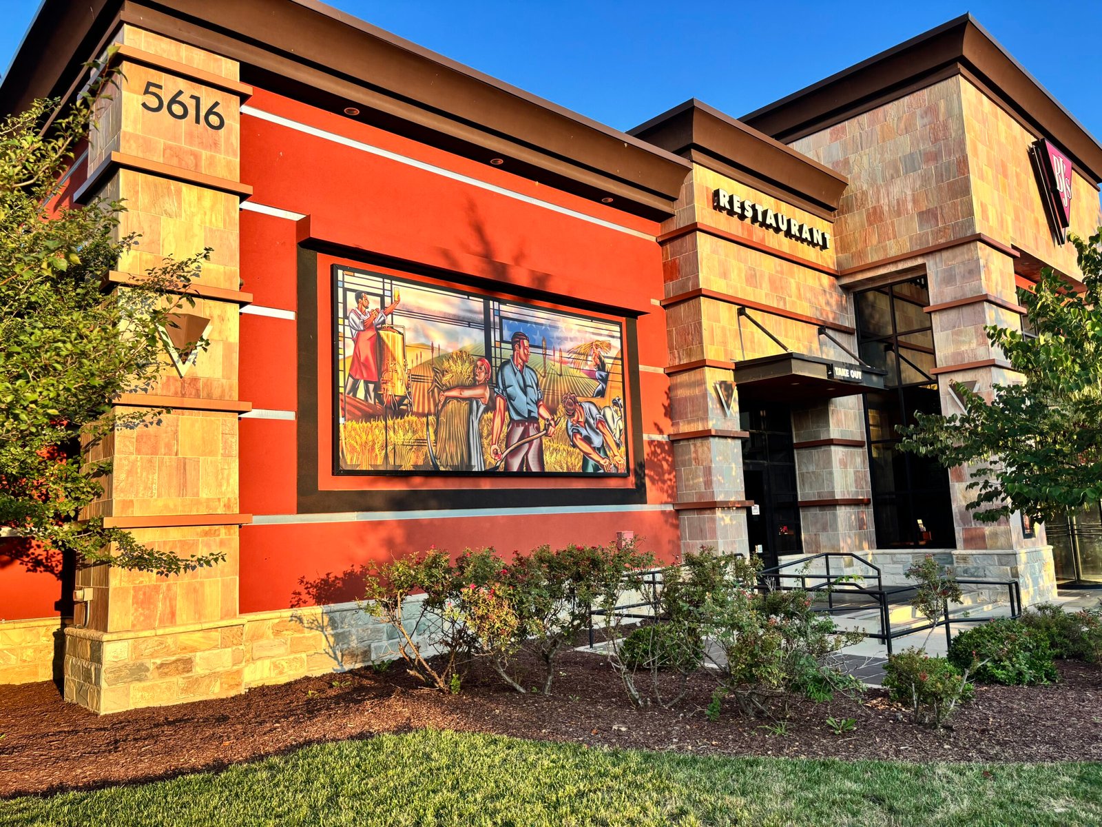 Finished exterior mural graphic at a restaurant entrance