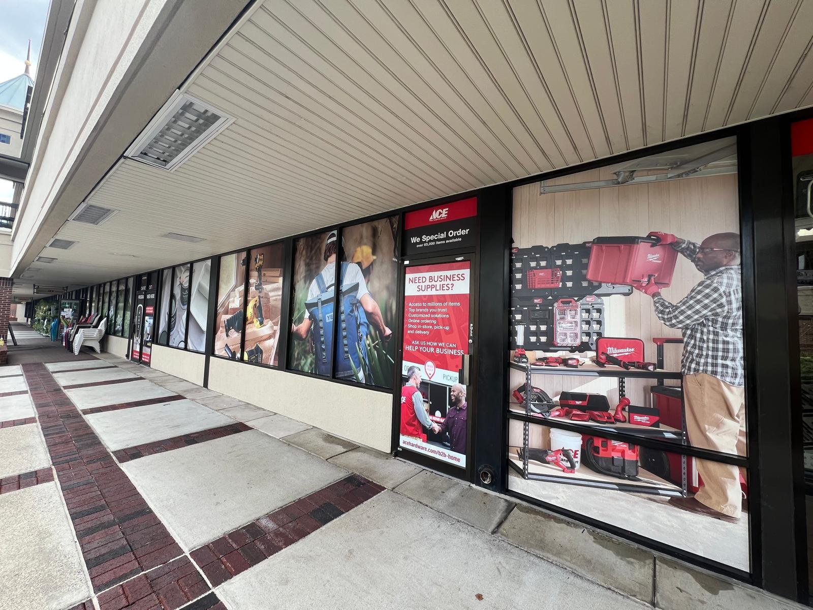 Colorful branded window graphics across a glass storefront