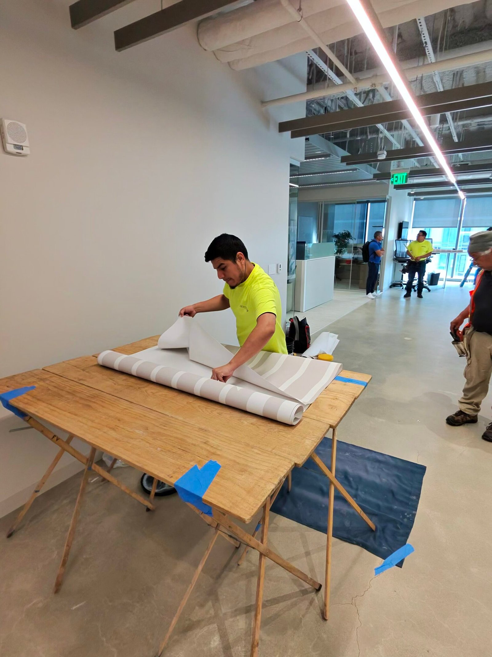 Installer preparing and unrolling wall graphics